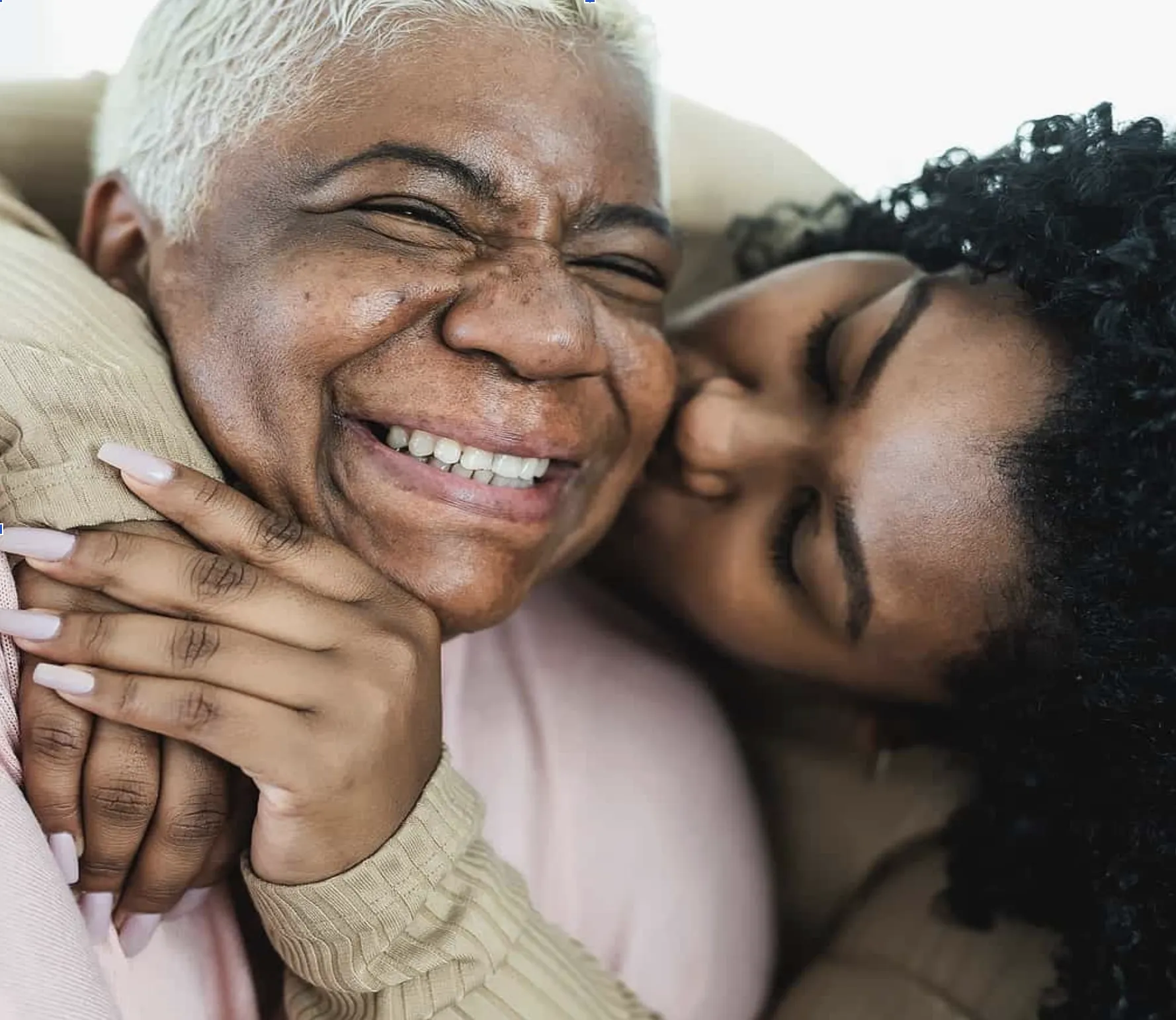 Senior living resident laughing with a family member